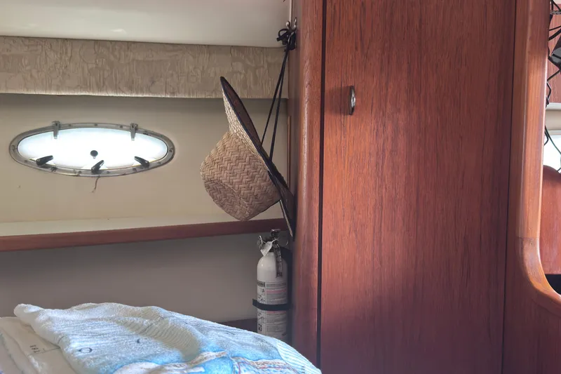 Slide: The Image of Interior of 2001 Tiara Yachts 3500 Open with wooden cabinetry and a straw hat. - 50