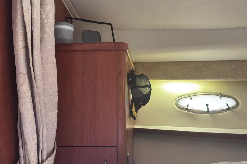 Slide: The Image of Interior of 2001 Tiara Yachts 3500 Open with wooden cabinet and porthole window. - 51