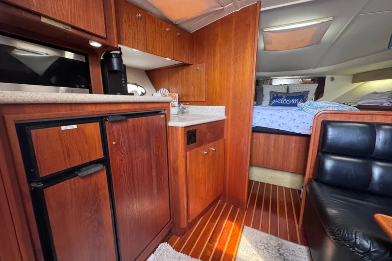 Slide: The Image of Interior of 2001 Tiara Yachts 3500 Open with kitchenette and cozy sleeping area. - 55