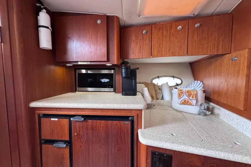 Slide: The Image of 2001 Tiara Yachts 3500 Open galley with wood cabinets and modern appliances. - 56