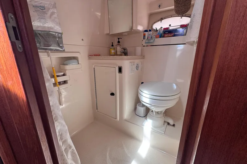 Slide: The Image of Bathroom interior of 2001 Tiara Yachts 3500 Open, featuring toilet and storage. - 58
