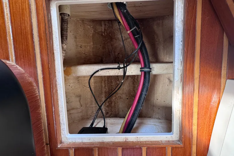Slide: The Image of Interior view of a 2001 Tiara Yachts 3500 Open, showing wiring and wooden paneling. - 59