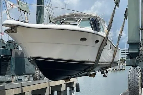 Slide: The Image of 2001 Tiara Yachts 3500 Open boat being lifted at a marina. - 6