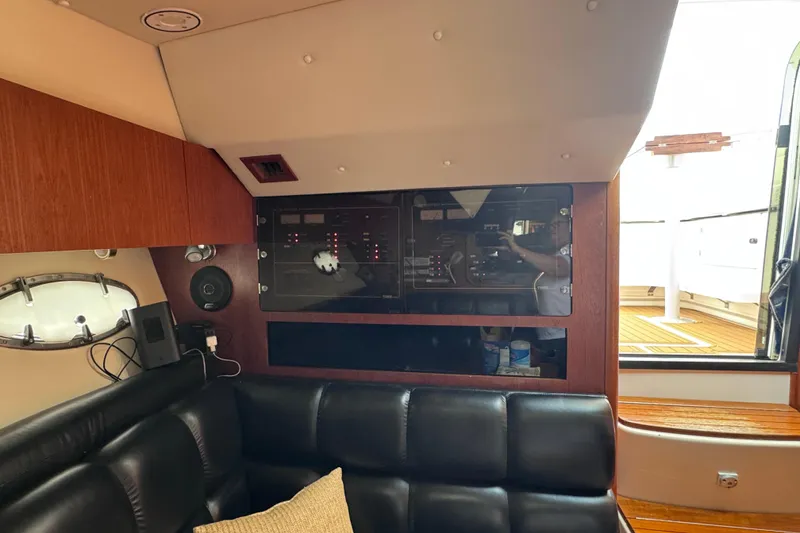 Slide: The Image of Interior of 2001 Tiara Yachts 3500 Open, featuring control panel and leather seating. - 60
