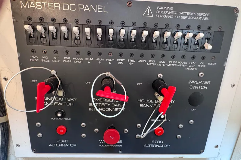 Slide: The Image of Master DC panel of 2001 Tiara Yachts 3500 Open with switches and warning label. - 62