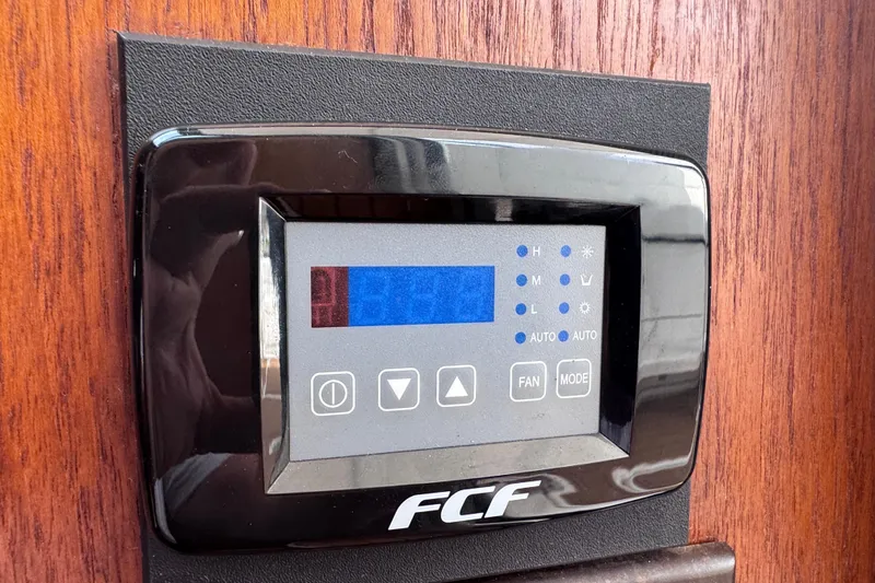 Slide: The Image of Control panel on 2001 Tiara Yachts 3500 Open, featuring FCF display and buttons. - 65