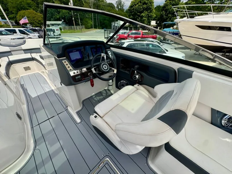 Slide: The Image of Interior of a 2021 Chaparral 30 Surf boat with modern helm console. - 12