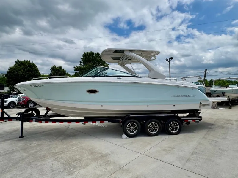 Slide: The Image of 2021 Chaparral 30 Surf boat on trailer, blue sky. - 3