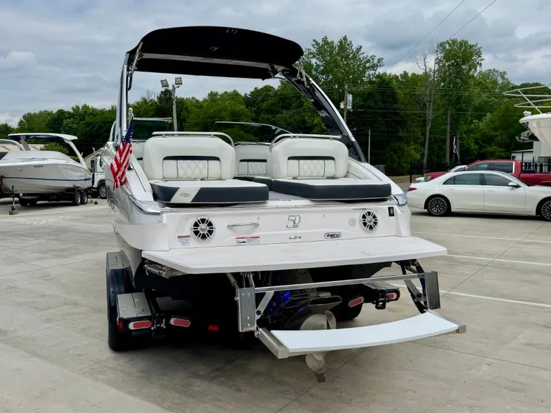 Slide: The Image of 2021 Regal LS4 boat parked outdoors on a trailer. - 11