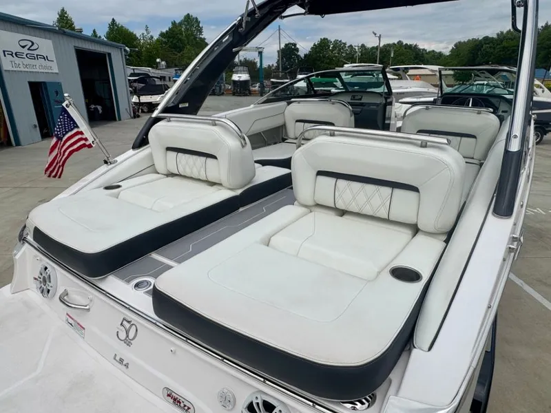 Slide: The Image of 2021 Regal LS4 boat with luxurious white seating outdoors. - 20