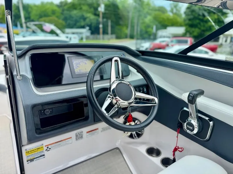 Slide: The Image of Interior view of 2021 Regal LS4 boat cockpit with steering wheel and controls. - 26