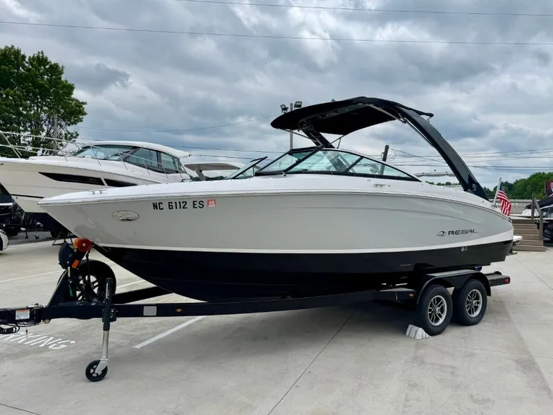Slide: The Image of 2021 Regal LS4 boat on trailer outdoors. - 6