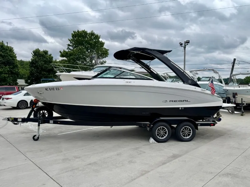 Slide: The Image of 2021 Regal LS4 boat parked on trailer outdoors. - 7