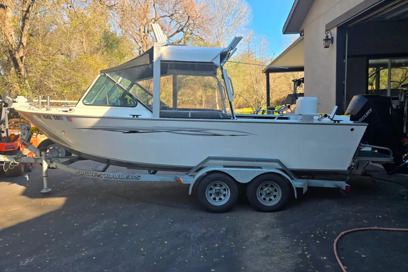 The Image of 2021 Alumaweld Intruder Outboard 20 boat on trailer, parked outdoors. - 1