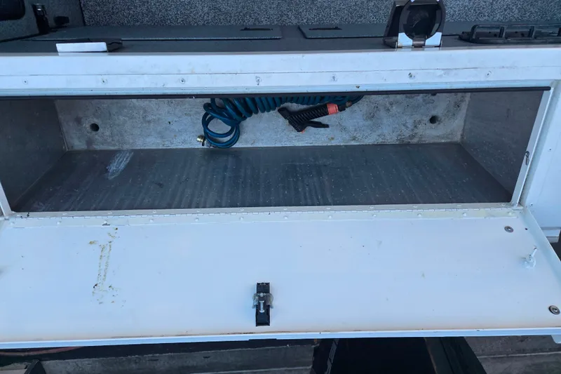 Slide: The Image of Open storage compartment in a 2021 Alumaweld Intruder Outboard 20 boat. - 11