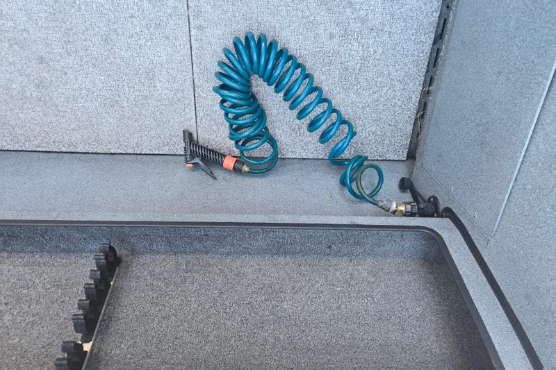Slide: The Image of Coiled blue hose in 2021 Alumaweld Intruder Outboard 20 boat interior. - 15