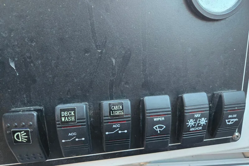 Slide: The Image of Control panel of a 2021 Alumaweld Intruder Outboard 20 boat with labeled switches. - 17