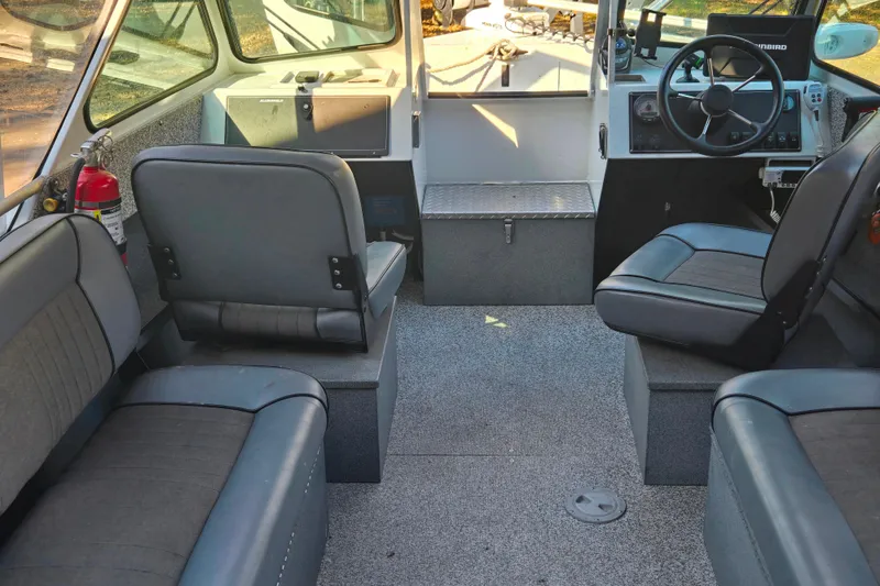 Slide: The Image of Interior of a 2021 Alumaweld Intruder Outboard 20 boat with seating and steering console. - 25
