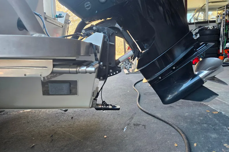 Slide: The Image of 2021 Alumaweld Intruder Outboard 20 motor and propeller in a garage setting. - 8