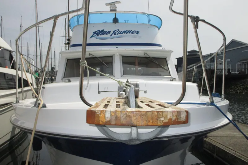 Slide: The Image of 1972 Uniflite 36 Sport Sedan boat docked at marina, front view. - 1