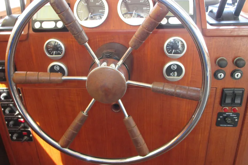 Slide: The Image of 1972 Uniflite 36 Sport Sedan helm with classic wooden steering wheel and gauges. - 19