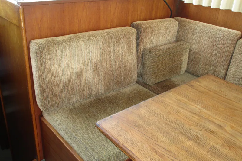 Slide: The Image of 1972 Uniflite 36 Sport Sedan interior with brown upholstered seating and wooden table. - 20
