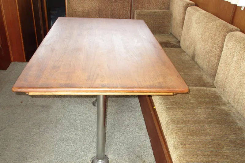 Slide: The Image of Interior of 1972 Uniflite 36 Sport Sedan with wooden table and cushioned seating. - 21