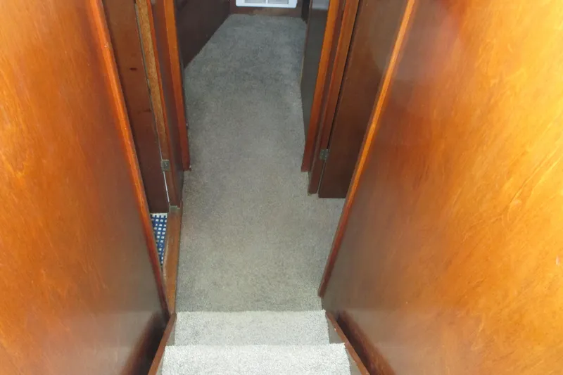 Slide: The Image of Interior hallway of 1972 Uniflite 36 Sport Sedan with wooden walls and carpeted floor. - 27