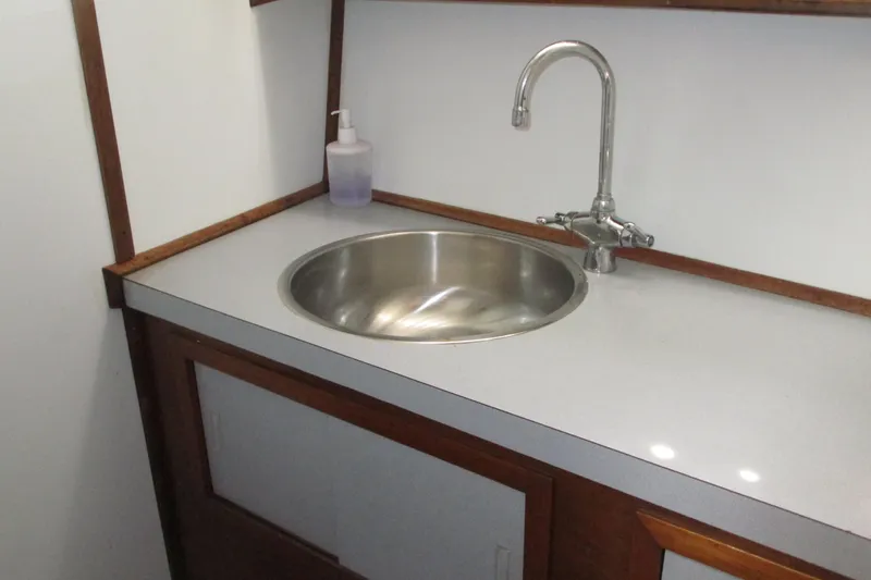 Slide: The Image of 1972 Uniflite 36 Sport Sedan boat sink with stainless steel basin and faucet. - 29