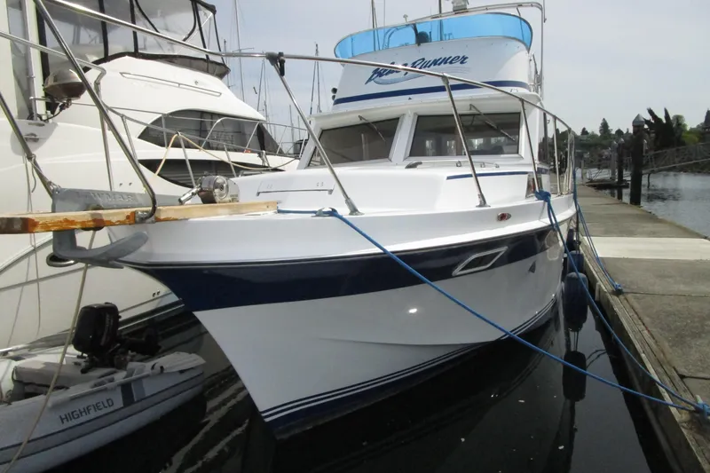 Slide: The Image of 1972 Uniflite 36 Sport Sedan docked at marina, featuring sleek design and blue accents. - 3