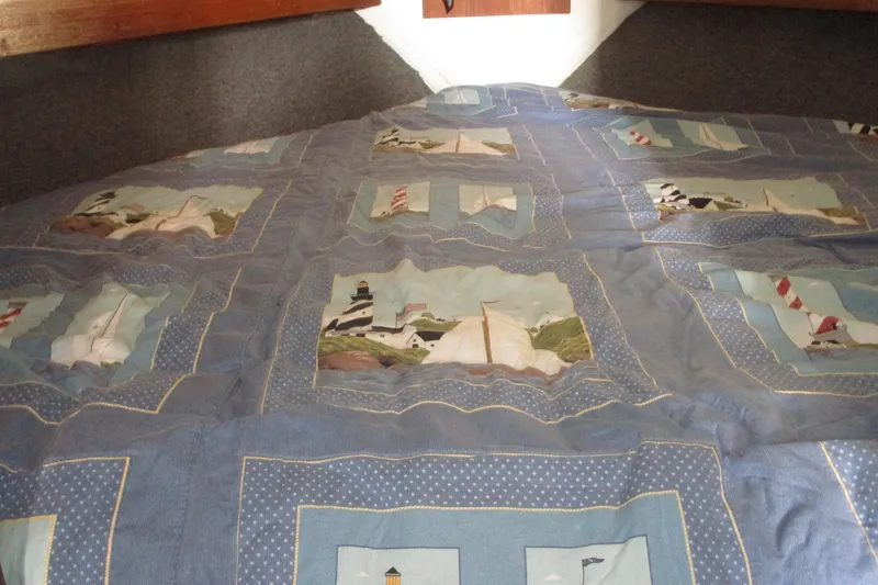 Slide: The Image of Quilted bedspread with nautical theme inside 1972 Uniflite 36 Sport Sedan boat cabin. - 32