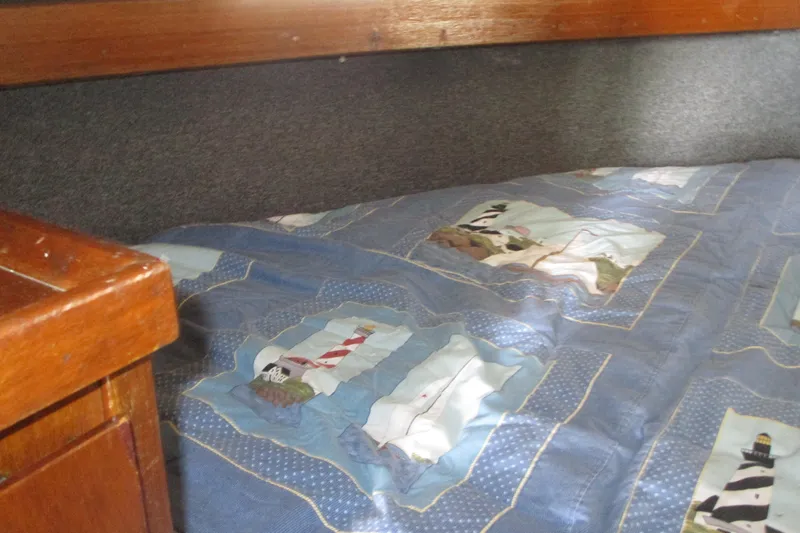 Slide: The Image of Cozy cabin interior of 1972 Uniflite 36 Sport Sedan with nautical-themed bedding. - 33
