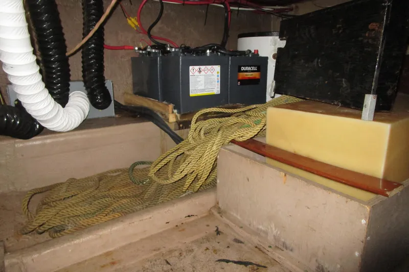 Slide: The Image of 1972 Uniflite 36 Sport Sedan engine room with battery, ropes, and ventilation hoses. - 36