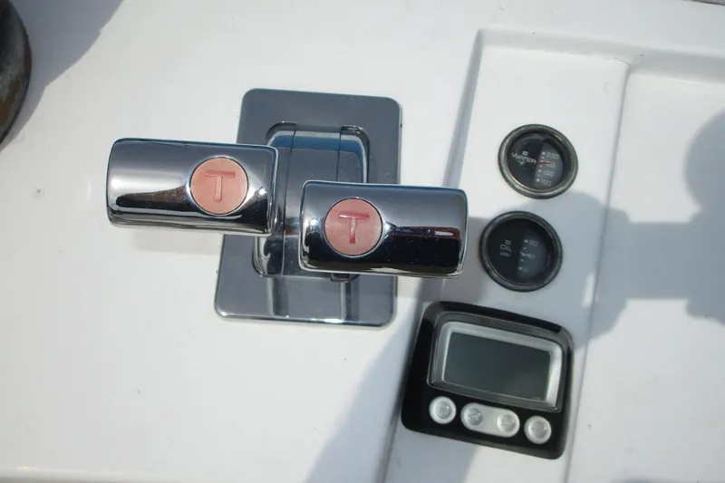 Slide: The Image of Chrome throttle controls and gauges on a 1972 Uniflite 36 Sport Sedan boat dashboard. - 8