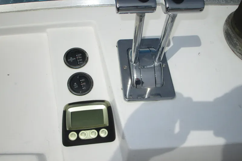Slide: The Image of 1972 Uniflite 36 Sport Sedan boat controls with gauges and levers. - 9