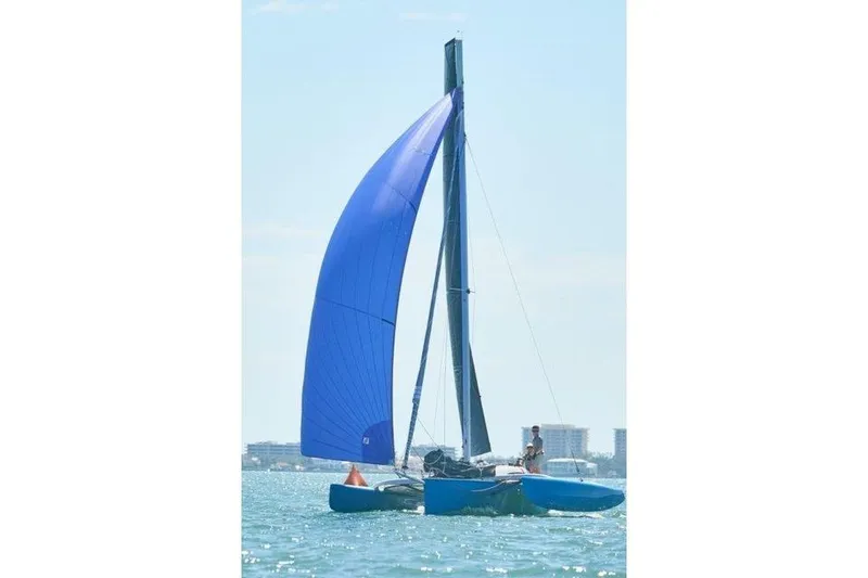 The Image of Sailing catamaran Farrier F-25C 1996 with blue sail on open water. - 1