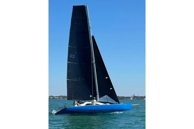 Slide: The Image of Sailing boat Farrier F-25C 1996 on blue water under clear sky. - 12