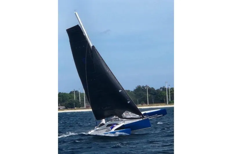 Slide: The Image of Sailing Farrier F-25C trimaran on open water, 1996 model, with black sails. - 3