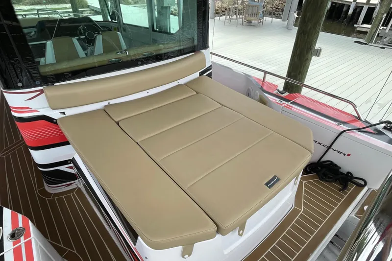 Slide: The Image of 2021 Axopar 28 Cabin boat with tan seating and sleek design. - 10