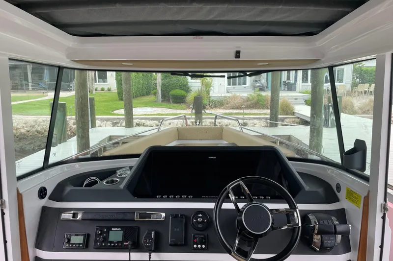 Slide: The Image of Interior view of 2021 Axopar 28 Cabin boat cockpit with steering wheel and dashboard. - 22