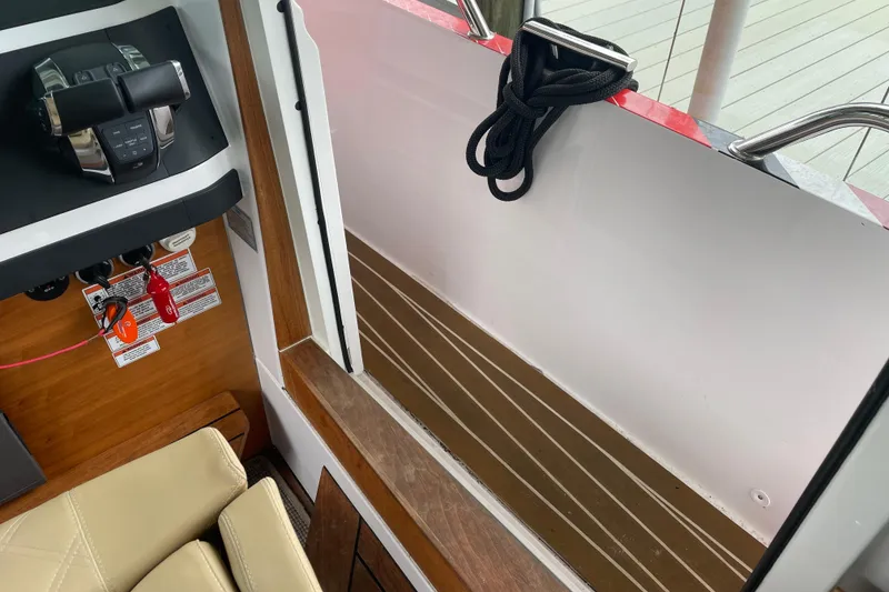 Slide: The Image of Interior view of 2021 Axopar 28 Cabin boat, featuring controls and seating. - 25
