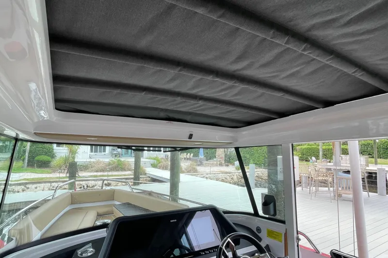 Slide: The Image of Interior view of 2021 Axopar 28 Cabin boat with helm and seating area. - 27