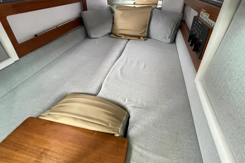 Slide: The Image of Cozy cabin interior of 2021 Axopar 28, featuring comfortable bedding and wooden accents. - 32