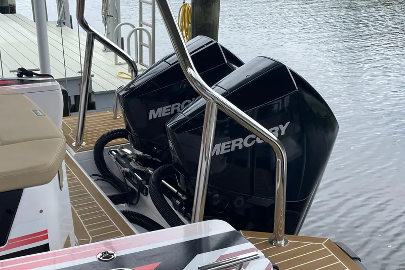 Slide: The Image of 2021 Axopar 28 Cabin with dual Mercury outboard engines docked by the water. - 36