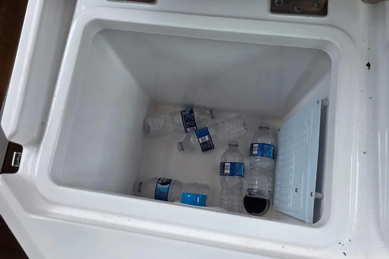 Slide: The Image of Cooler with water bottles inside Axopar 28 Cabin boat, 2021 model. - 43
