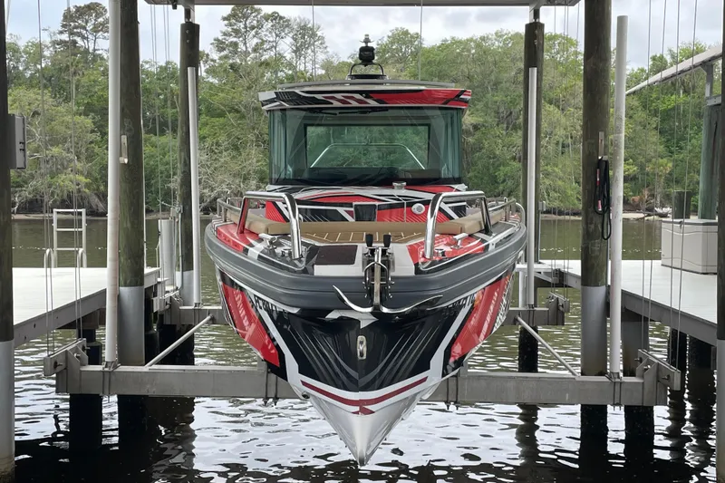 Slide: The Image of 2021 Axopar 28 Cabin boat docked, featuring sleek design and vibrant colors. - 5