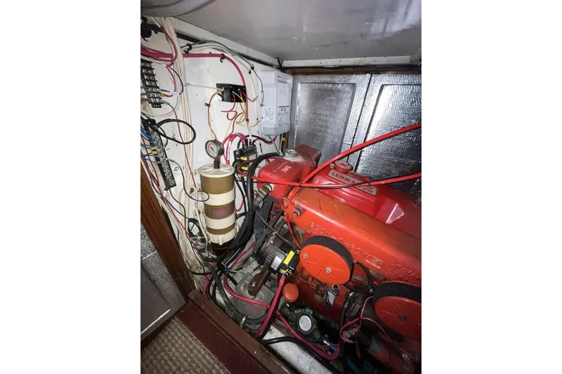 Slide: The Image of Engine room of a 1979 Hardin 44 sailboat with wiring and components. - 10