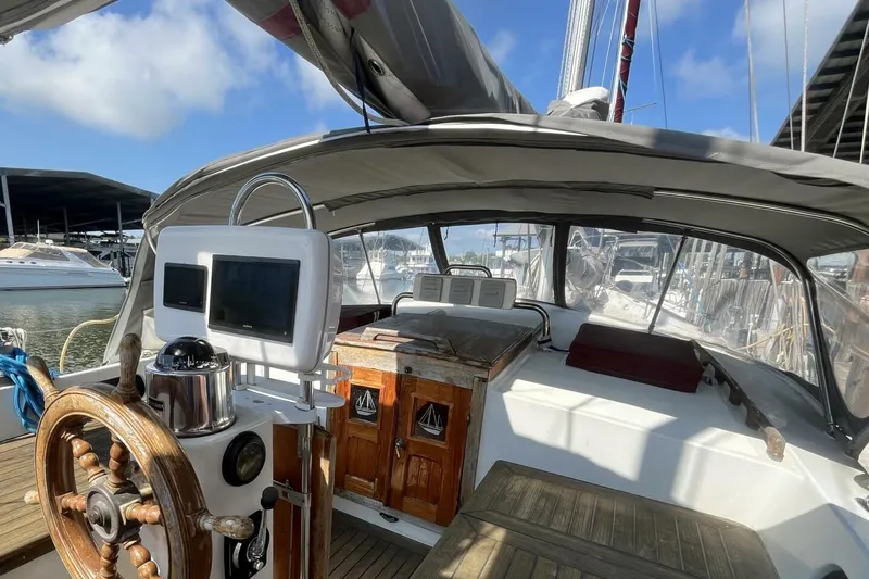 Slide: The Image of Cockpit of a 1979 Hardin 44 sailboat with wooden wheel and navigation equipment. - 3