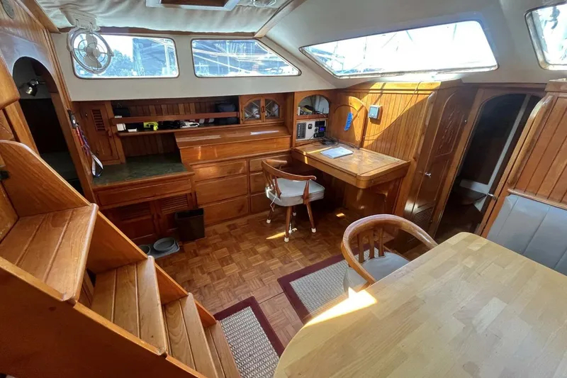Slide: The Image of Interior of a 1979 Hardin 44 sailboat with wooden furnishings and natural light. - 4