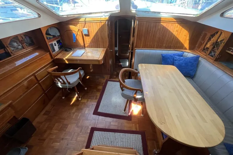 Slide: The Image of Interior of a 1979 Hardin 44 sailboat with wooden furnishings and seating area. - 6